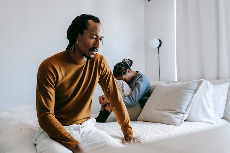 Black Couple Having Conflict On Bed