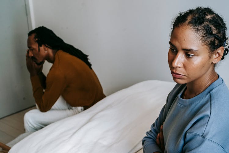 Black Couple Spending Time On Bed With Sad Face