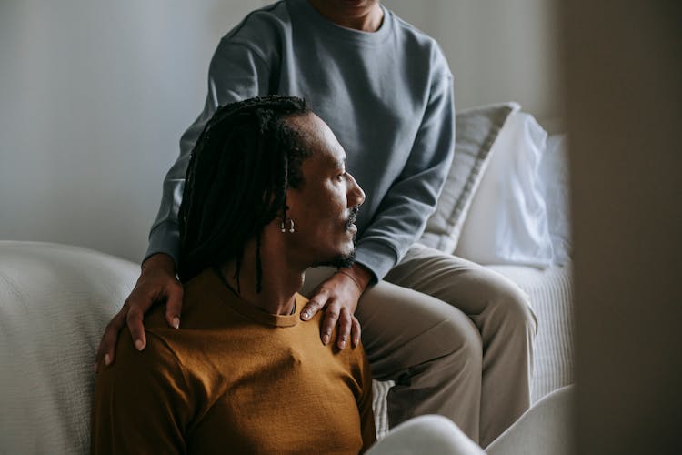 African American Couple Resting In Bedroom Together