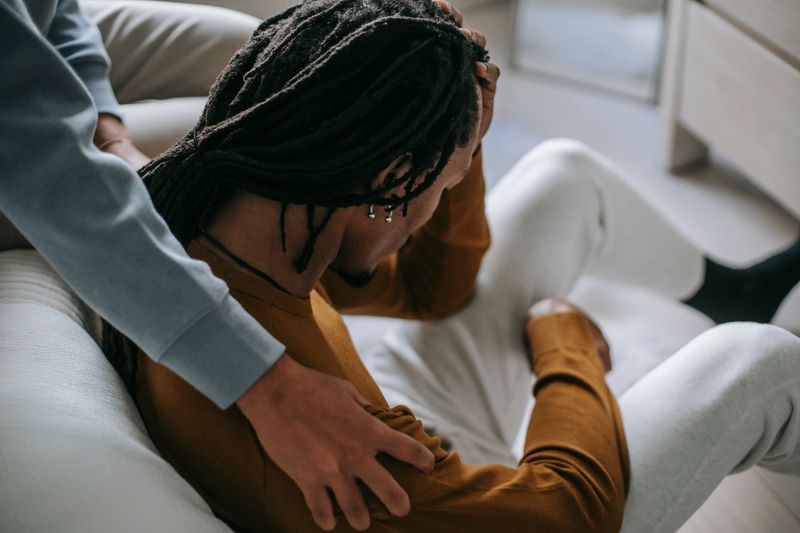 Faceless African American couple pastime together in room representing shared clinical support