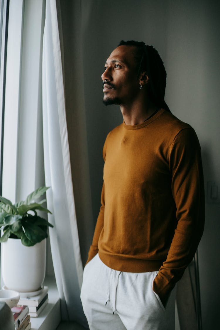 African American Man Standing In Room Alone