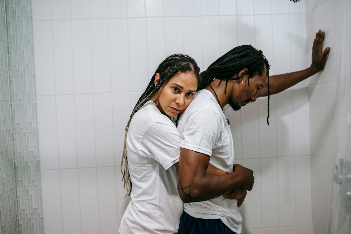 Free Sad black loving couple hugging in bathroom after argument Stock Photo