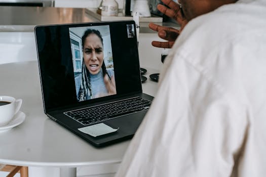 A couple having a heated video call conversation in a kitchen setting.