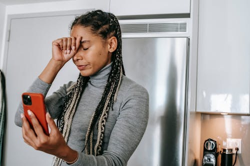 Sad young ethnic lady arguing during video call