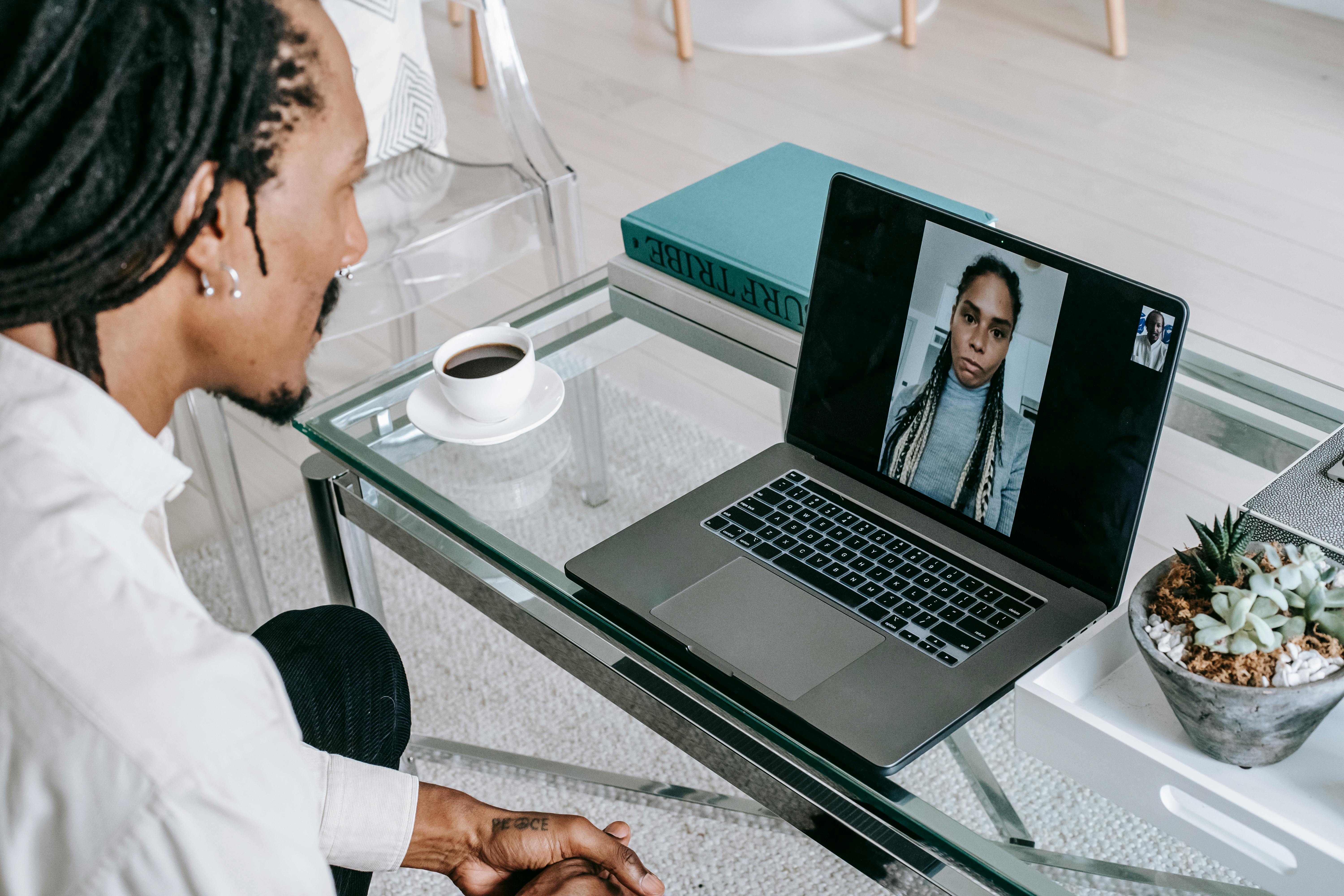 young black guy having video chat on netbook with girlfriend