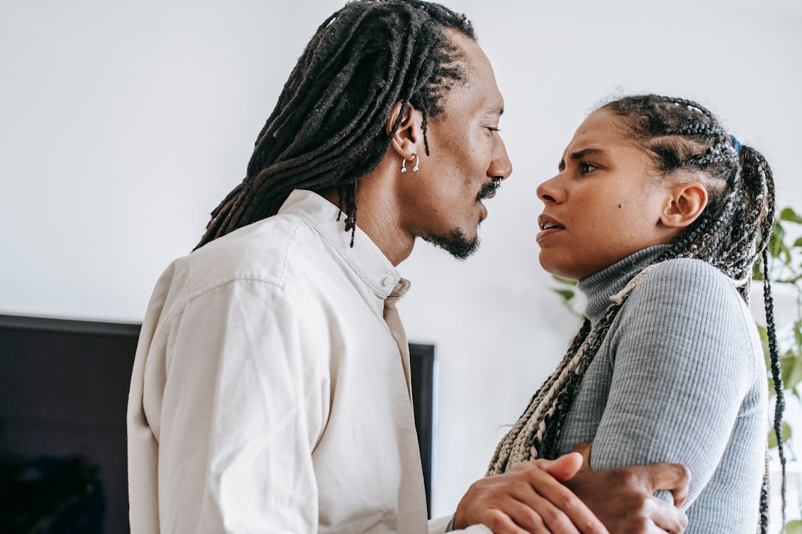 Black couple quarreling together in apartment