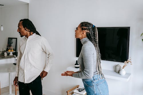 Free Emotional black couple standing in cozy apartment and having conflict while spending time together Stock Photo