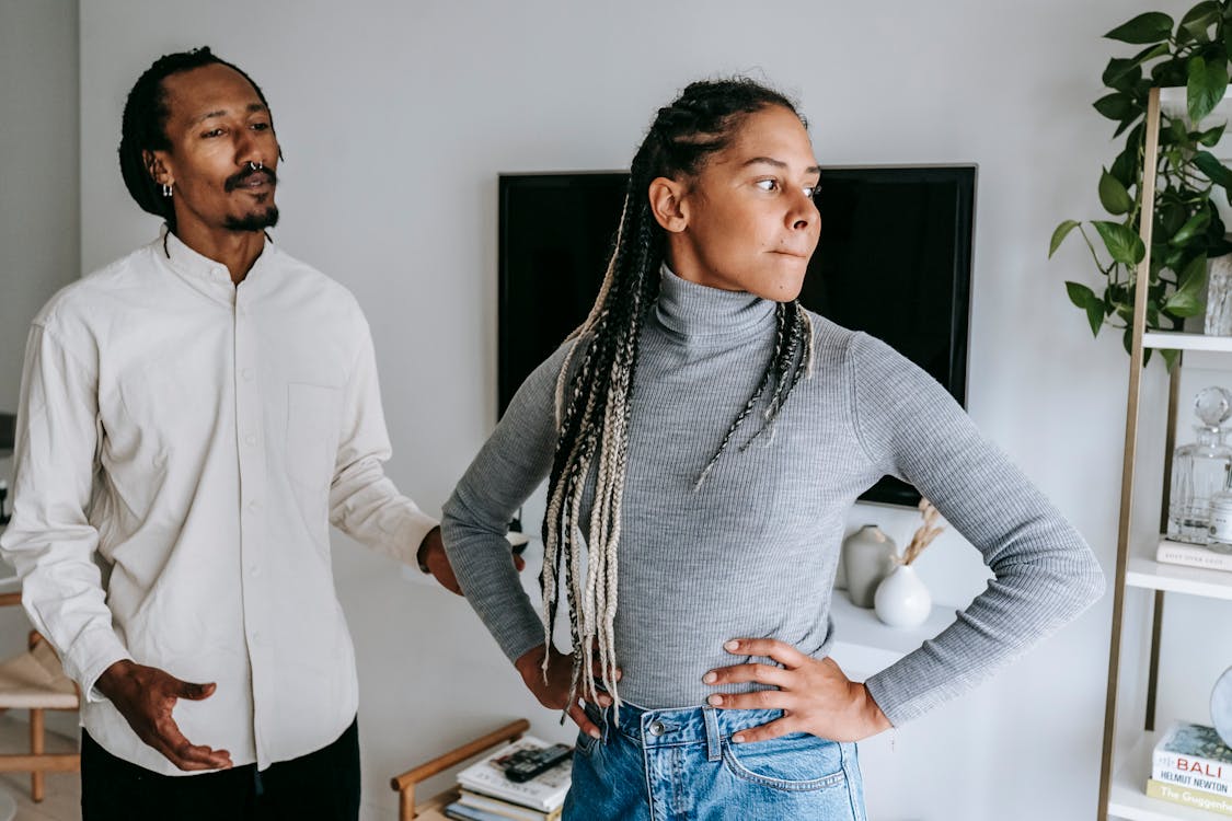 Free Unhappy African American couple quarreling while spending time together in light modern apartment Stock Photo