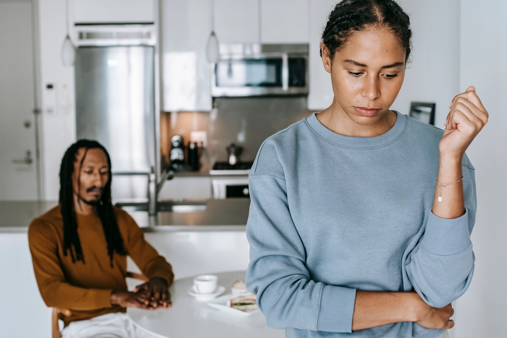 Crop unhappy black woman with boyfriend at home