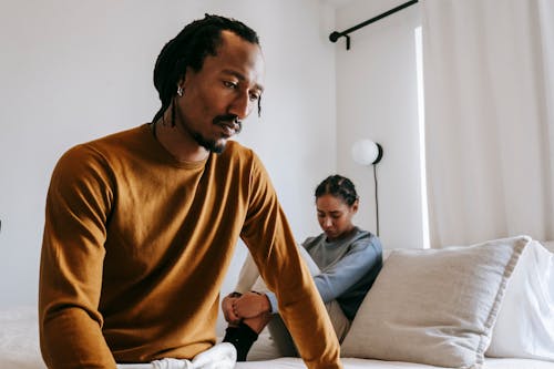 Upset black couple during dispute in bedroom