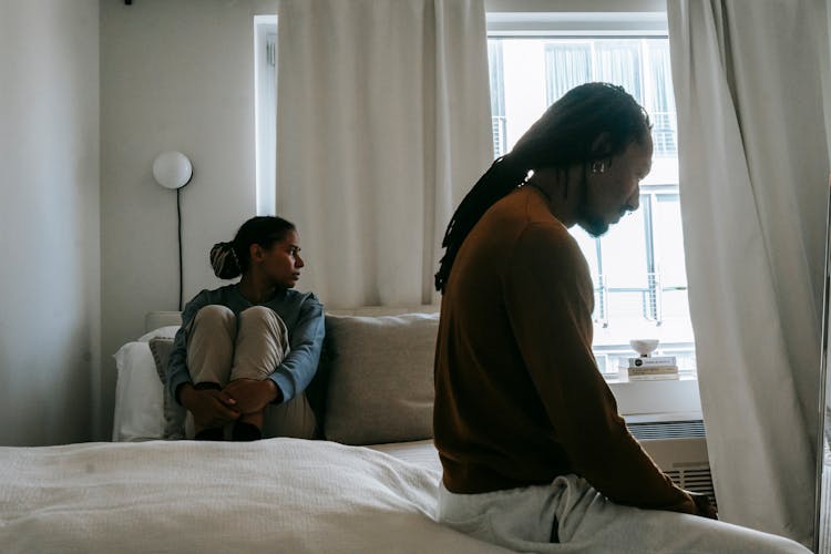 Sad African American Couple During Quarrel On Bed