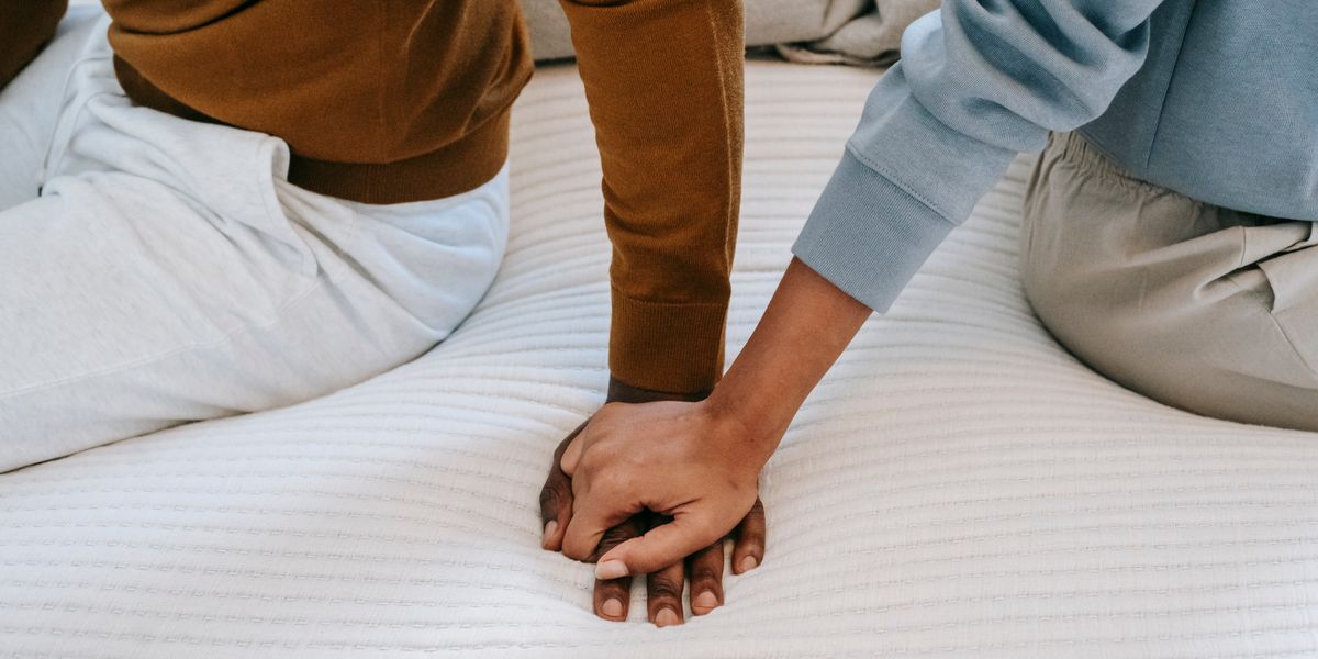 A couple sitting close together and holding hands, a quiet moment of closeness