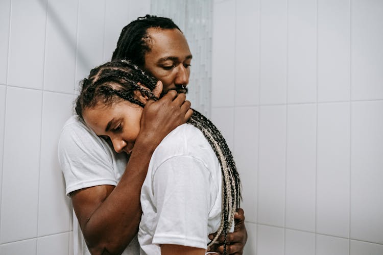 Wistful Black Couple Hugging In Bathroom