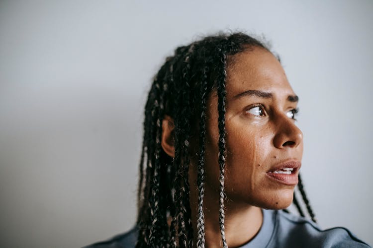 Mournful Black Woman Crying In Light Room