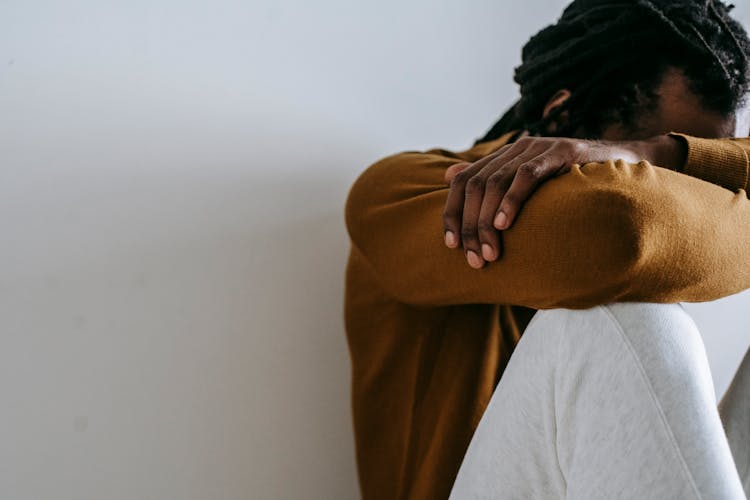 Crop Faceless Overwhelmed Black Man Covering Face Against Wall