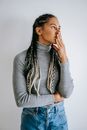 Concerned black woman touching face in contemplation
