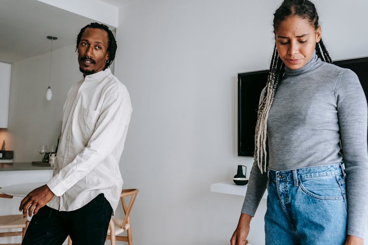 Arguing Black Couple Standing In Living Room