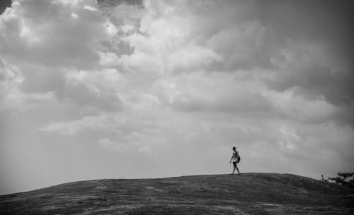 A Photo of a Person Walking Alone