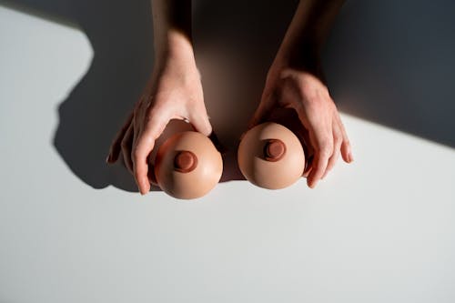 Person Holding 2 White Eggs