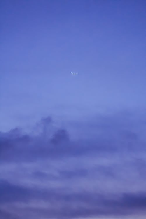 Moon on blue sky with clouds · Free Stock Photo