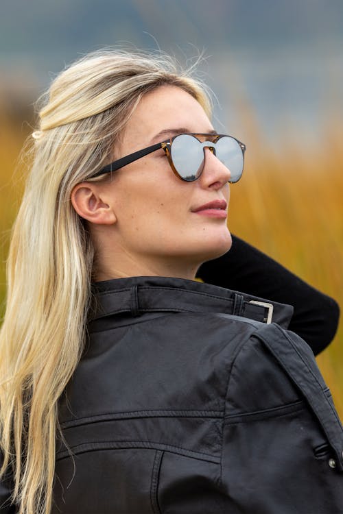 Stylish woman in sunglasses in nature