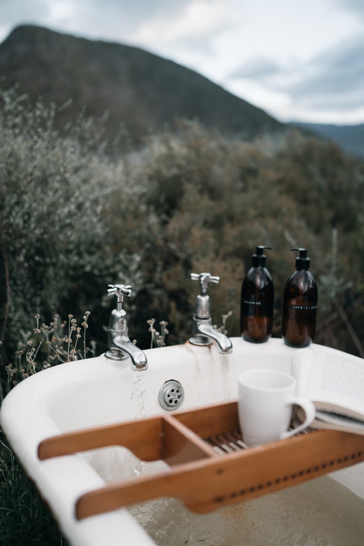 An Image Of Open Faucets Of A Bathtub