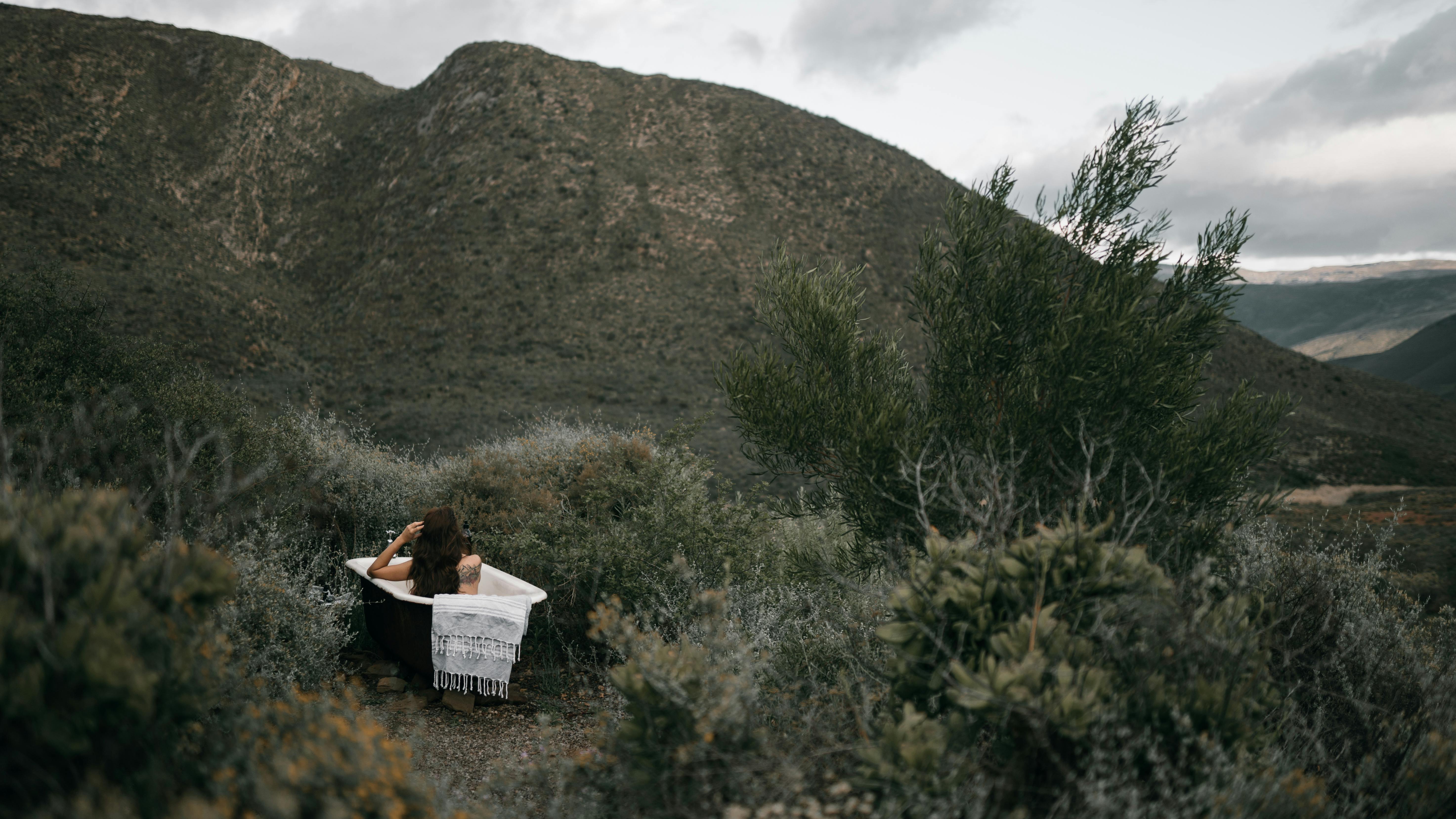 woman taking a bath outdoors