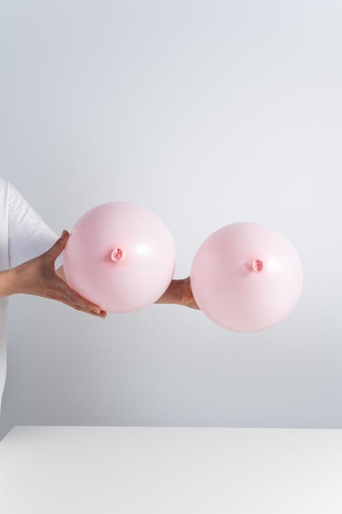Free 2 Pink Balloons on White Wall Stock Photo