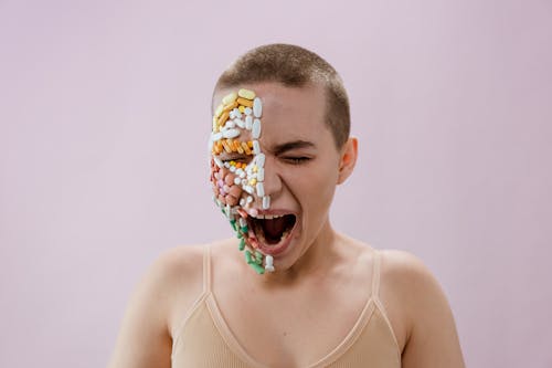 Woman in White Tank Top With Yellow and Blue Floral Face Paint