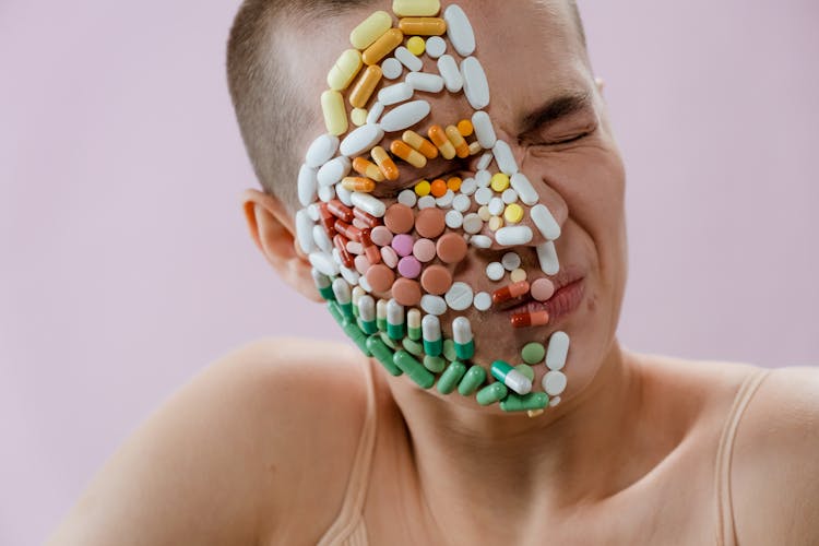  Assorted Medicines On Woman's Face