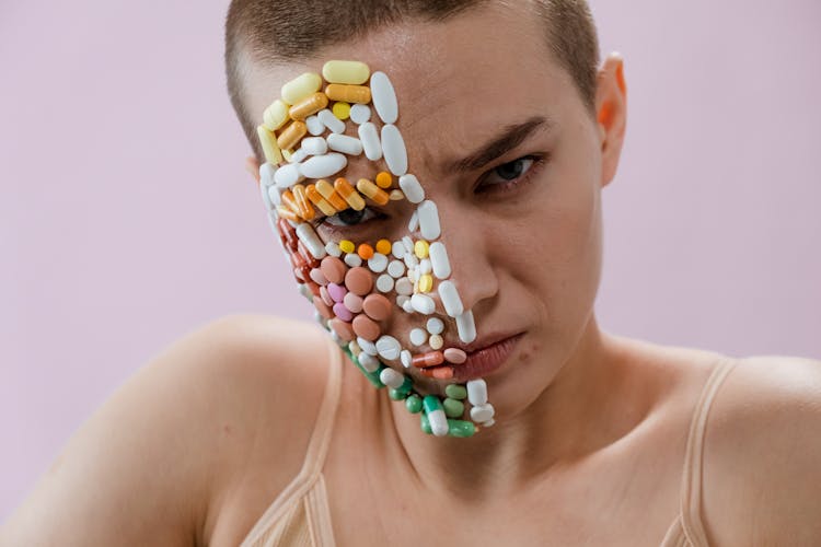 Assorted Medicines On Woman's Face