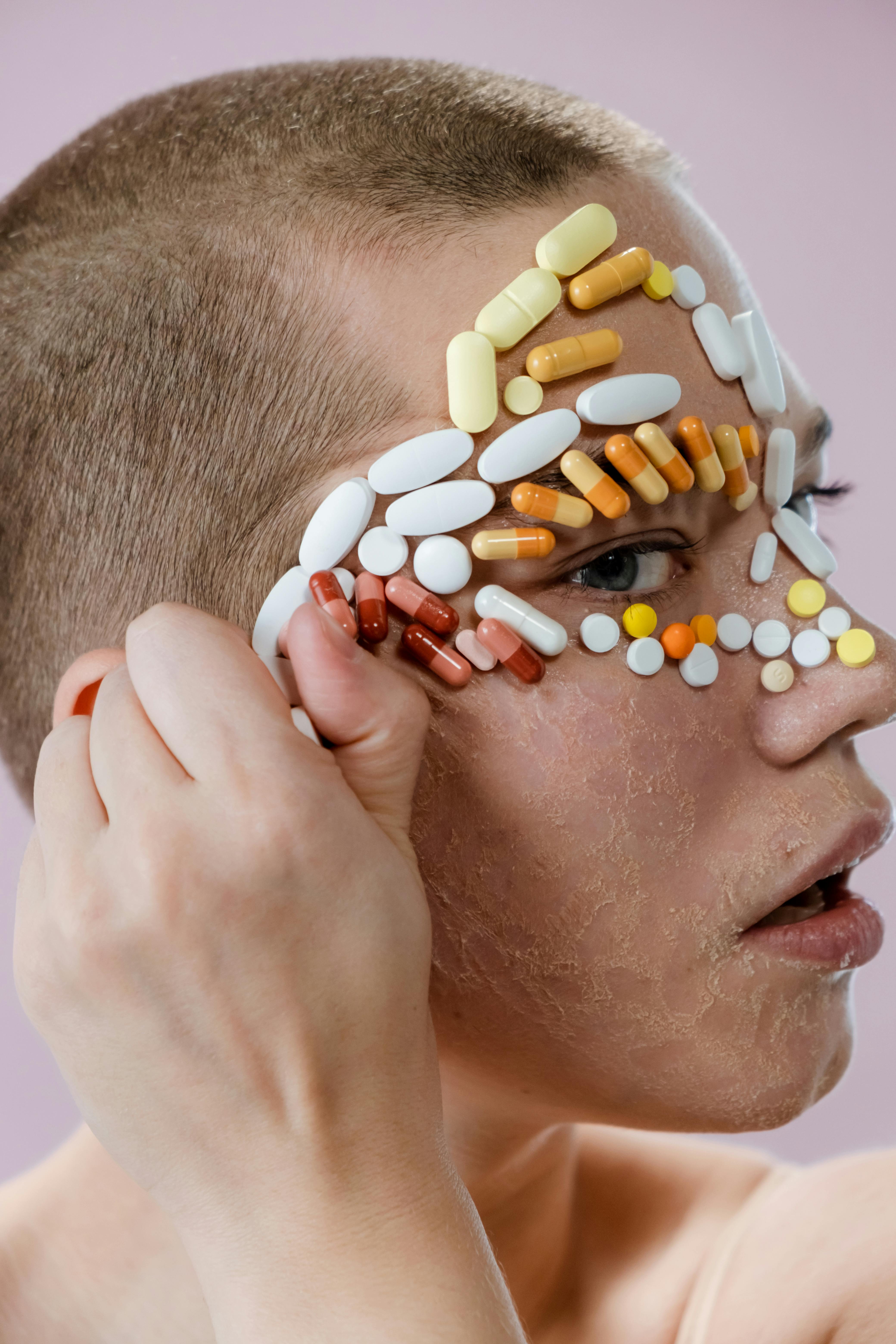 woman removing assorted medicine pills on her face