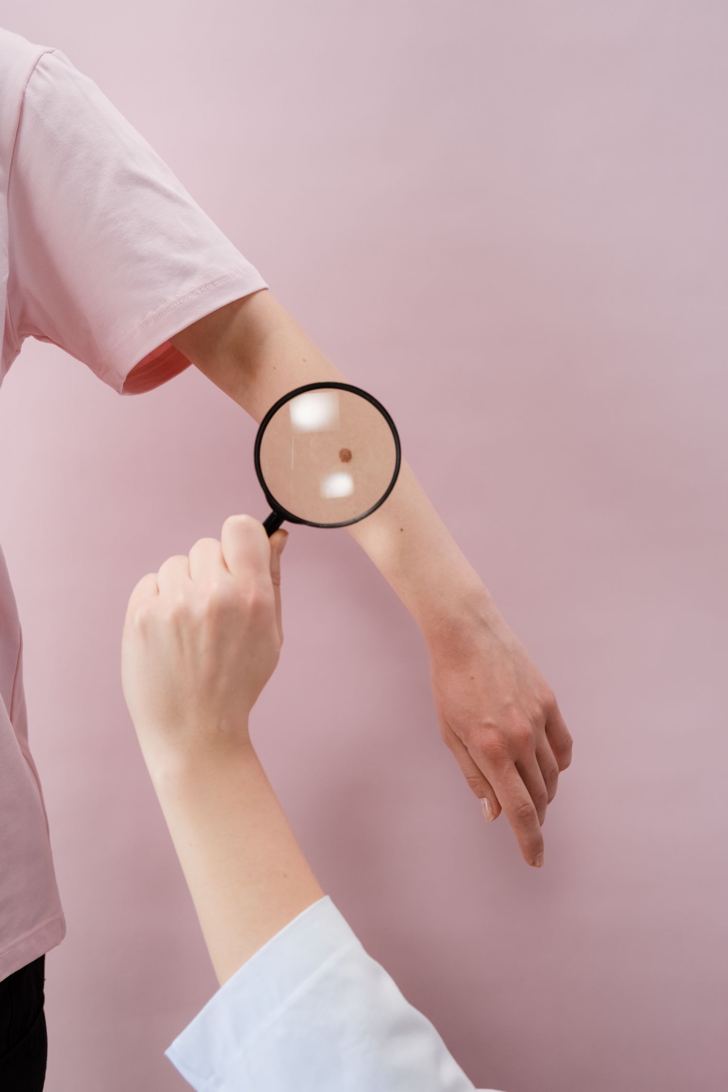 Dermatologist examining a patient's skin during a consultation