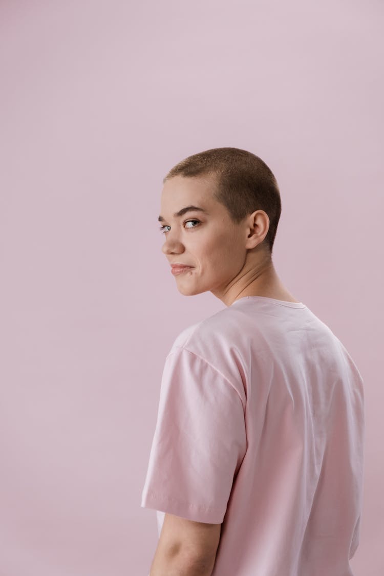 A Woman With Short Hair Wearing A Pink Shirt