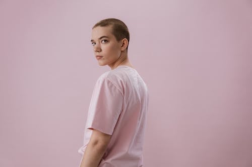 A Woman in Pink Shirt with Shaved Head
