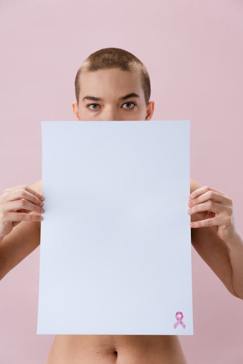 Woman Holding a White Paper with Pink Ribbon