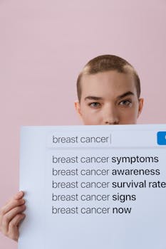 Woman holding a sign on breast cancer awareness with a serious expression.