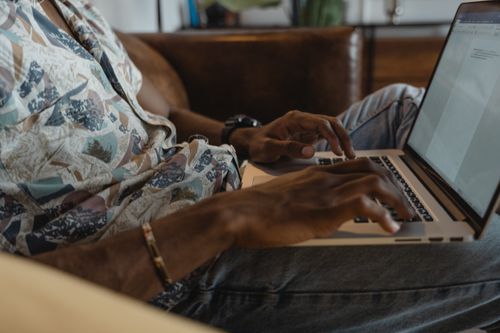 Free Close-up of individual typing on a laptop indoors, ideal for remote work or online learning themes. Stock Photo