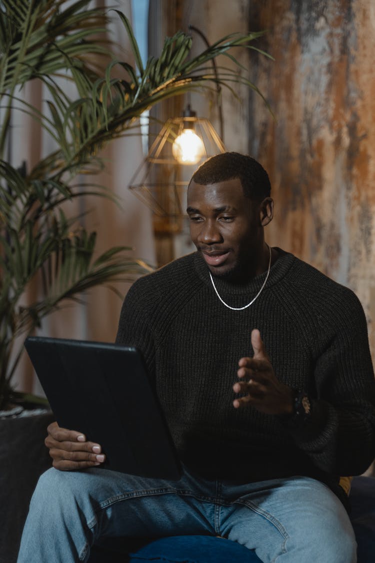 Man In Black Sweater Using Black Laptop Computer