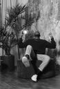 Man in Black Long Sleeve Shirt and Pants Sitting on Chair