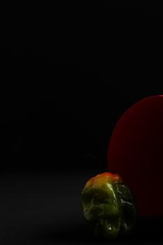 Close-up of a green bell pepper with black background and copy space.