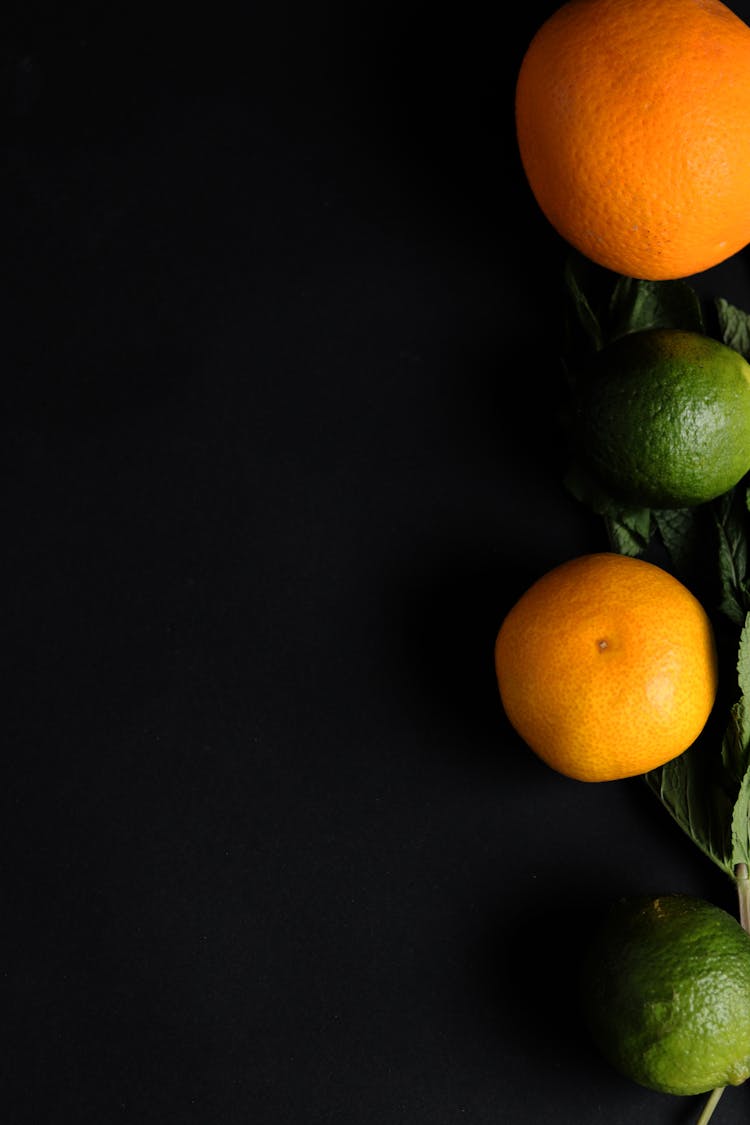 Citrus Fruits On Black Background