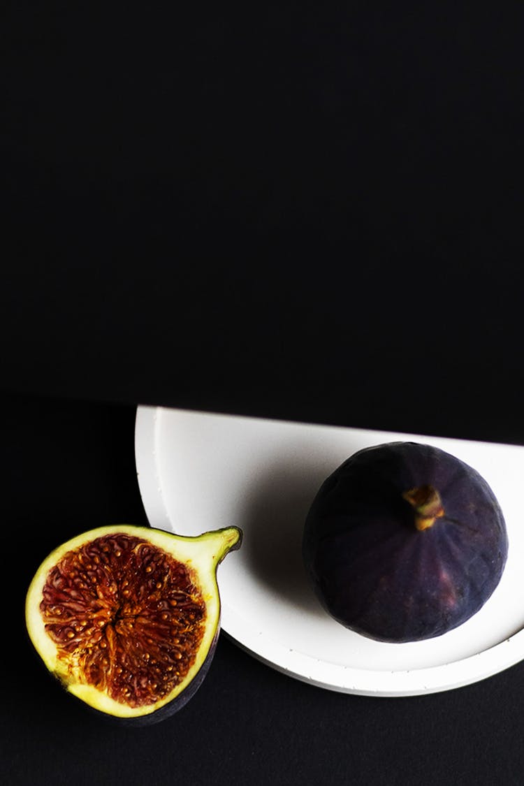 Whole Fig Fruit And A Slice With Black Background