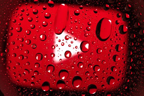 Free Water Droplets on Red Surface Stock Photo