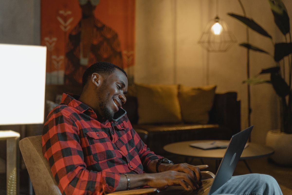 Person comfortably checking online loan comparison options on a laptop from home