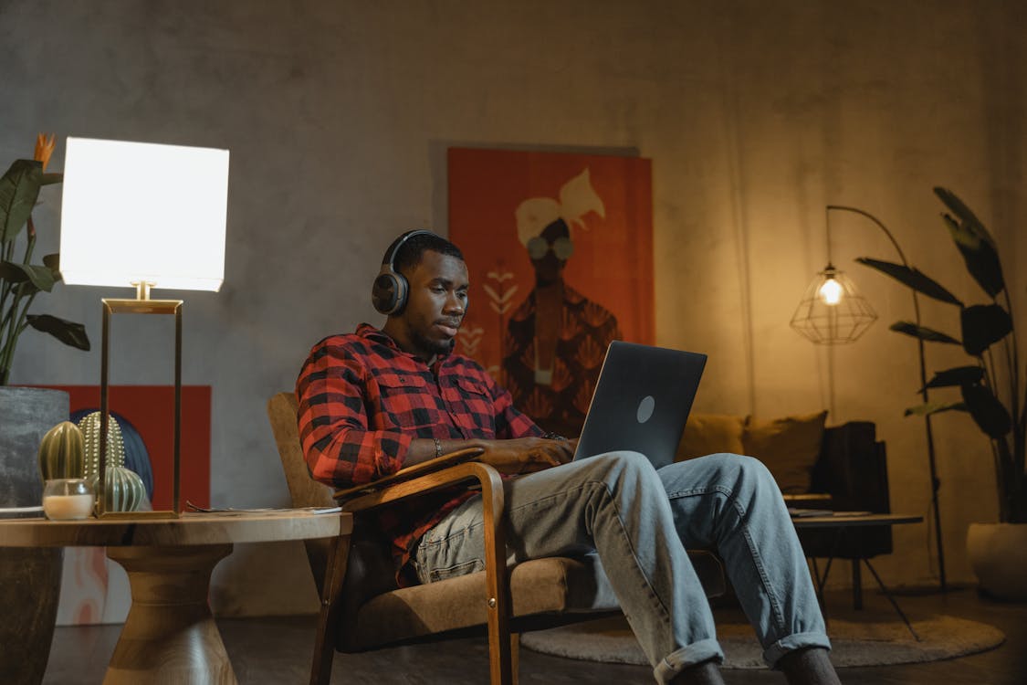 Man in Red and White Plaid Dress Shirt Using Macbook