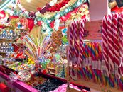 Vibrant candy display in a Paris shop with assorted sweets and holiday decorations.
