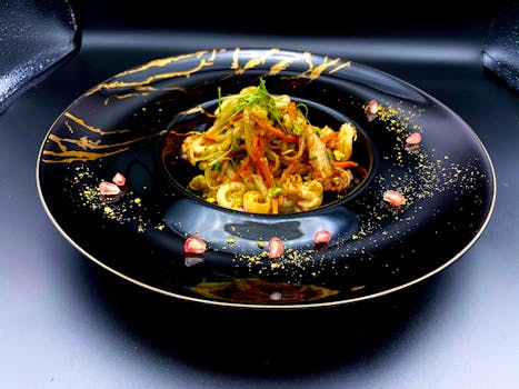 A stunning gourmet pasta dish beautifully presented on an artistic black plate.