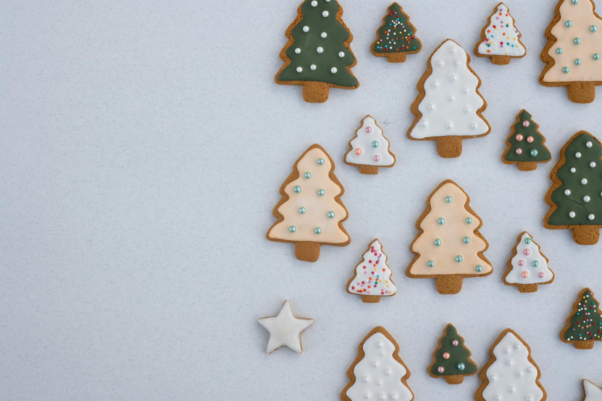 Different Sizes of Christmas Tree-Shaped Gingerbread Cookies on White Background