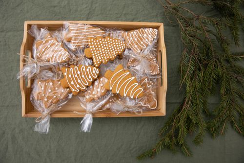 Free Gingerbread cookies shaped like Christmas trees in a wooden tray with fir branches. Stock Photo